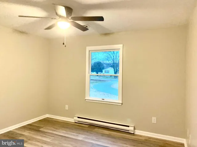an empty room with wooden floor