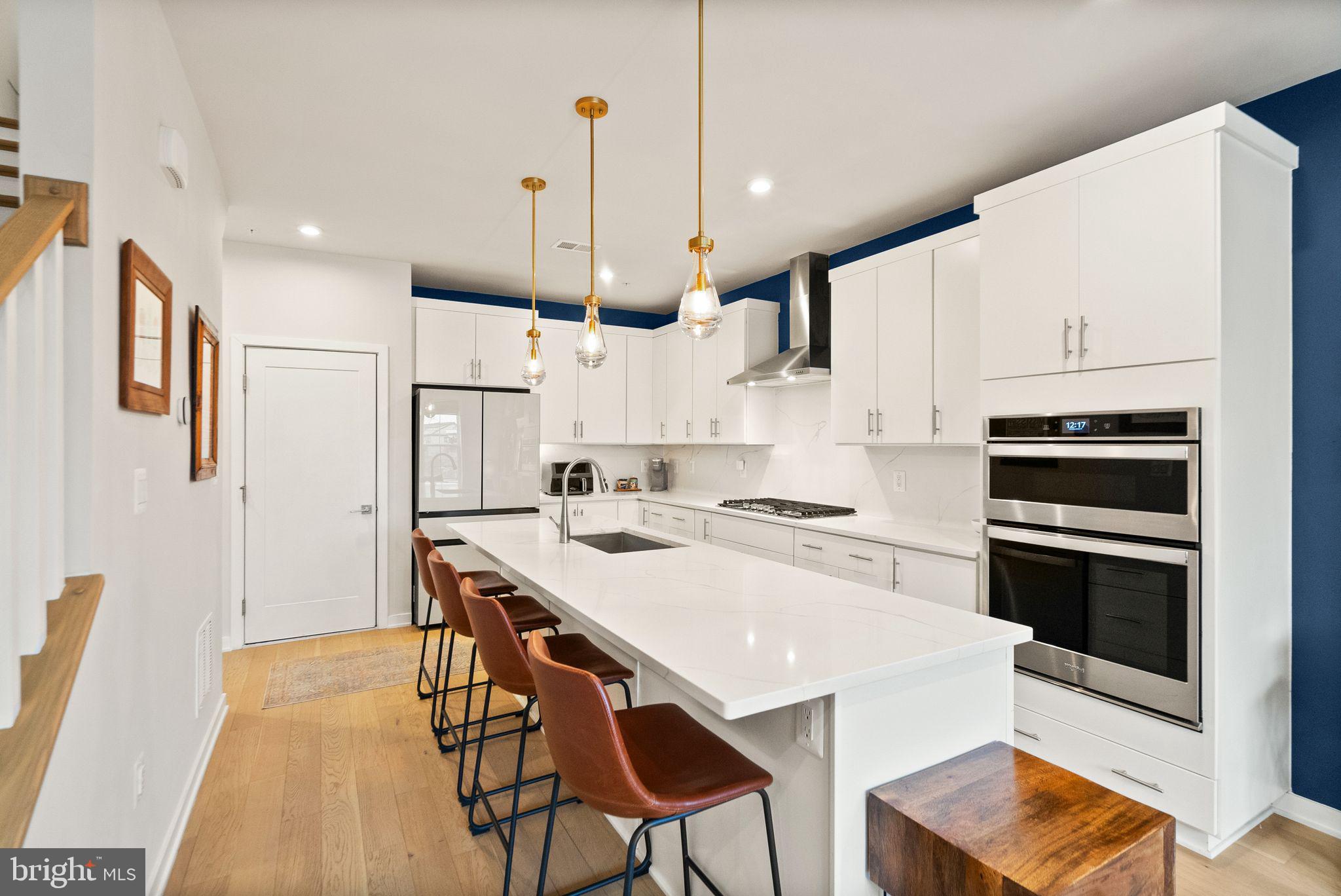 43553 Charitable Street Ashburn, VA 20148 - Photo 12 of 63 a kitchen with stainless steel appliances kitchen island a refrigerator and a stove top oven