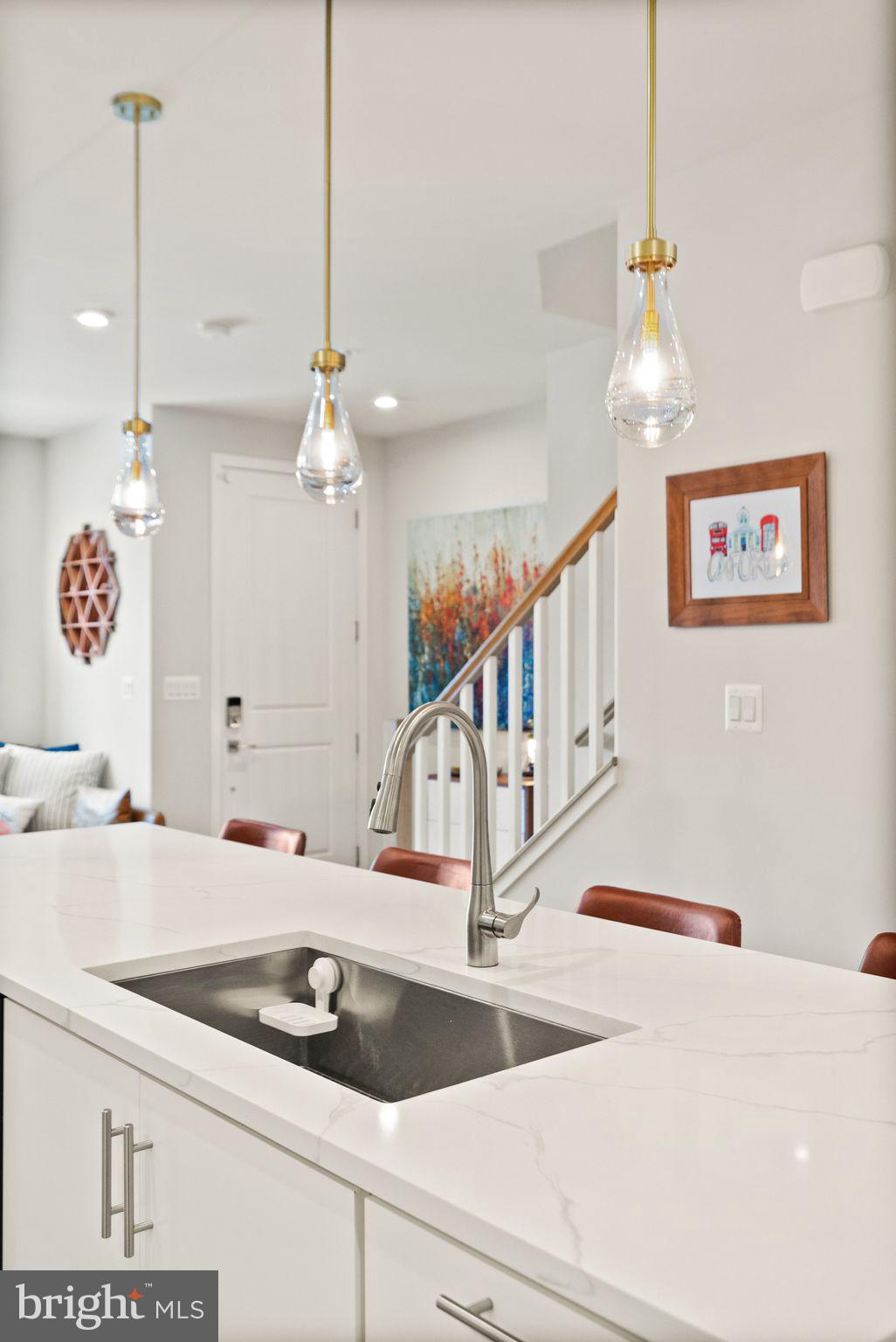 43553 Charitable Street Ashburn, VA 20148 - Photo 17 of 63 a kitchen with kitchen island a sink and a chandelier