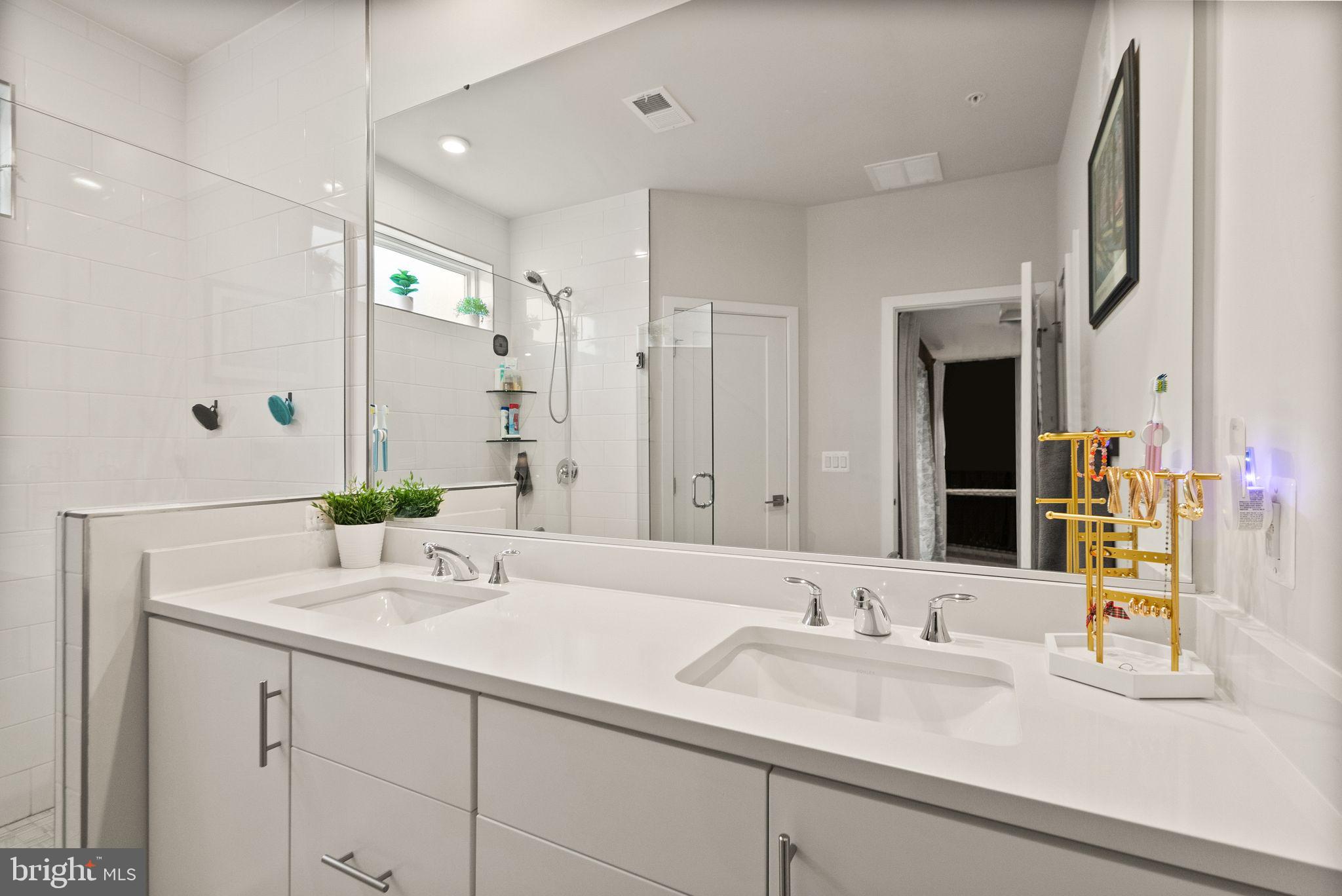 43553 Charitable Street Ashburn, VA 20148 - Photo 35 of 63 a bathroom with double vanity sinks and a mirror