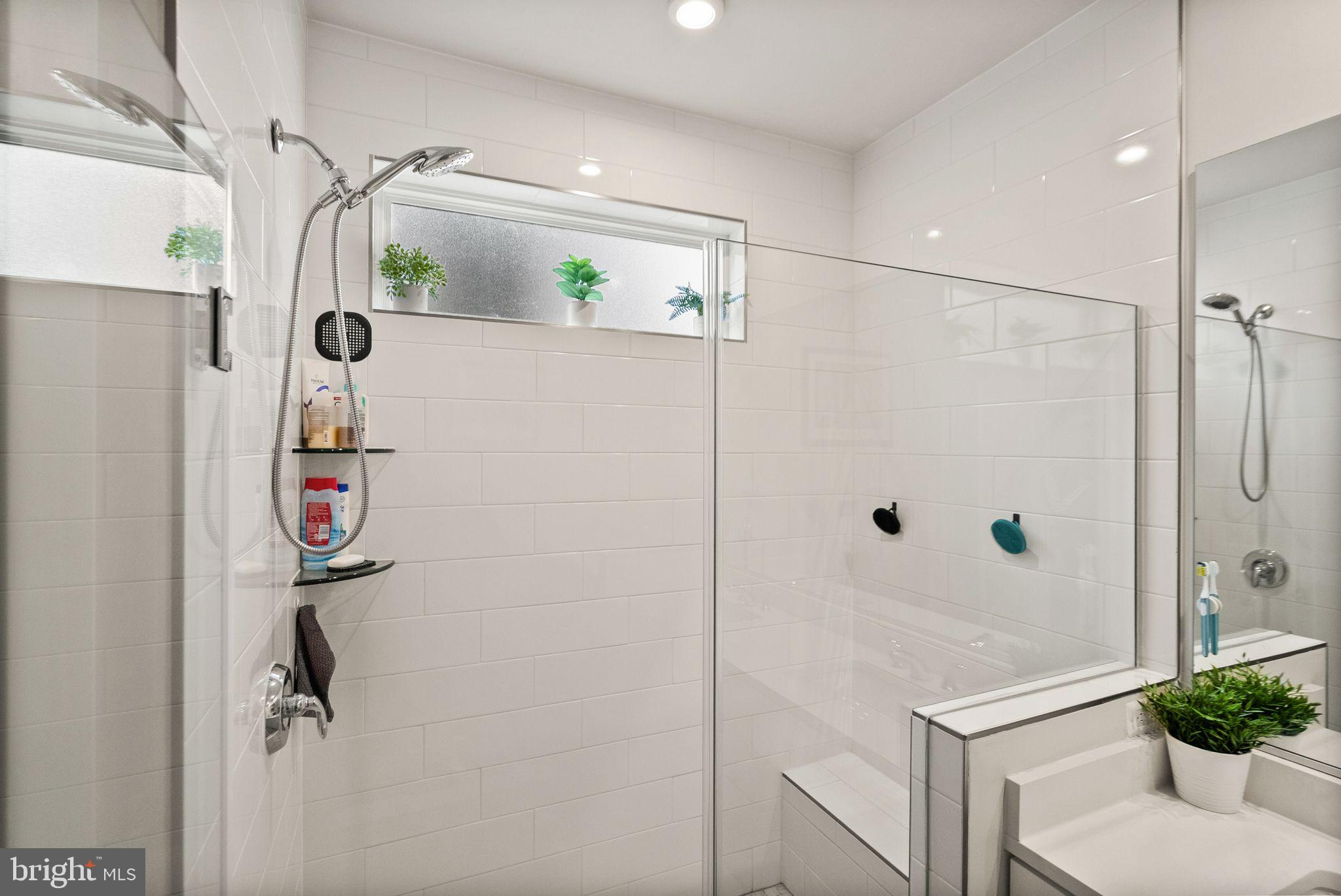 43553 Charitable Street Ashburn, VA 20148 - Photo 36 of 63 a bathroom with a shower and a mirror