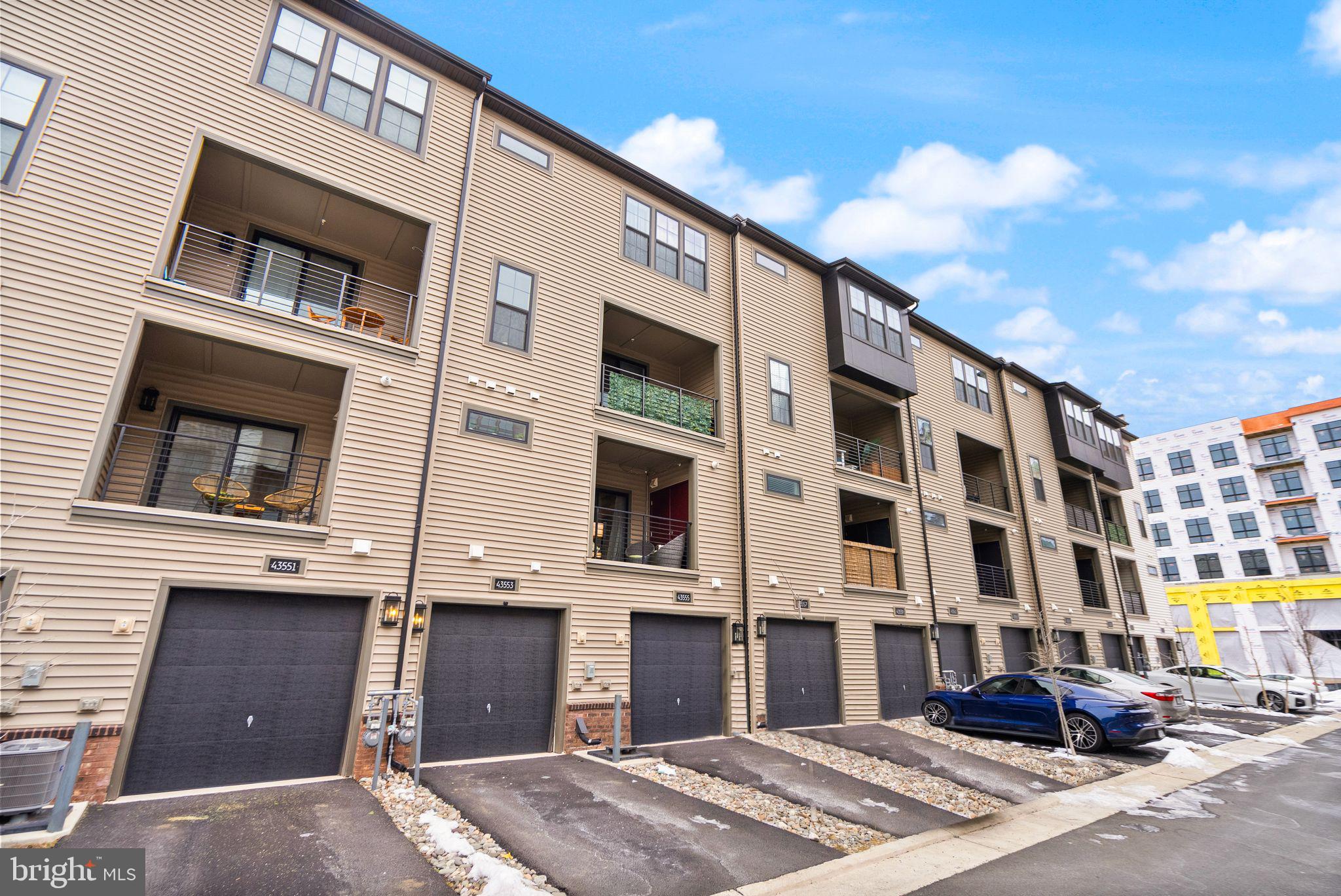 43553 Charitable Street Ashburn, VA 20148 - Photo 50 of 63 a front view of a building and a street
