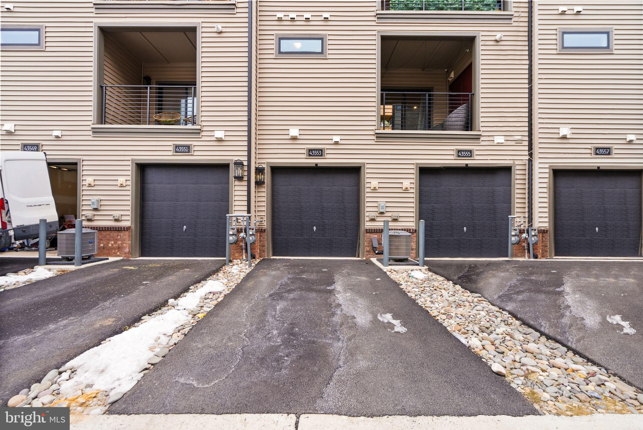 43553 Charitable Street Ashburn, VA 20148 - Photo 51 of 63 a front view of a house with a yard and garage