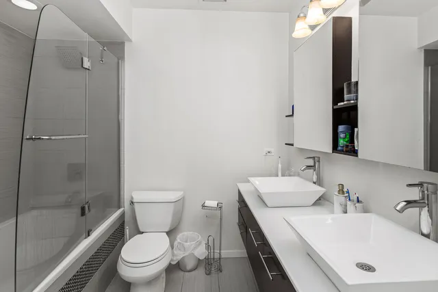 a bathroom with a sink toilet and shower