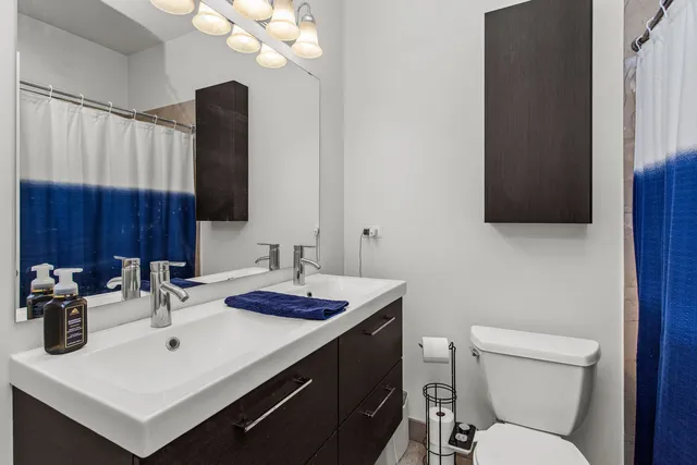 a bathroom with a sink vanity and toilet