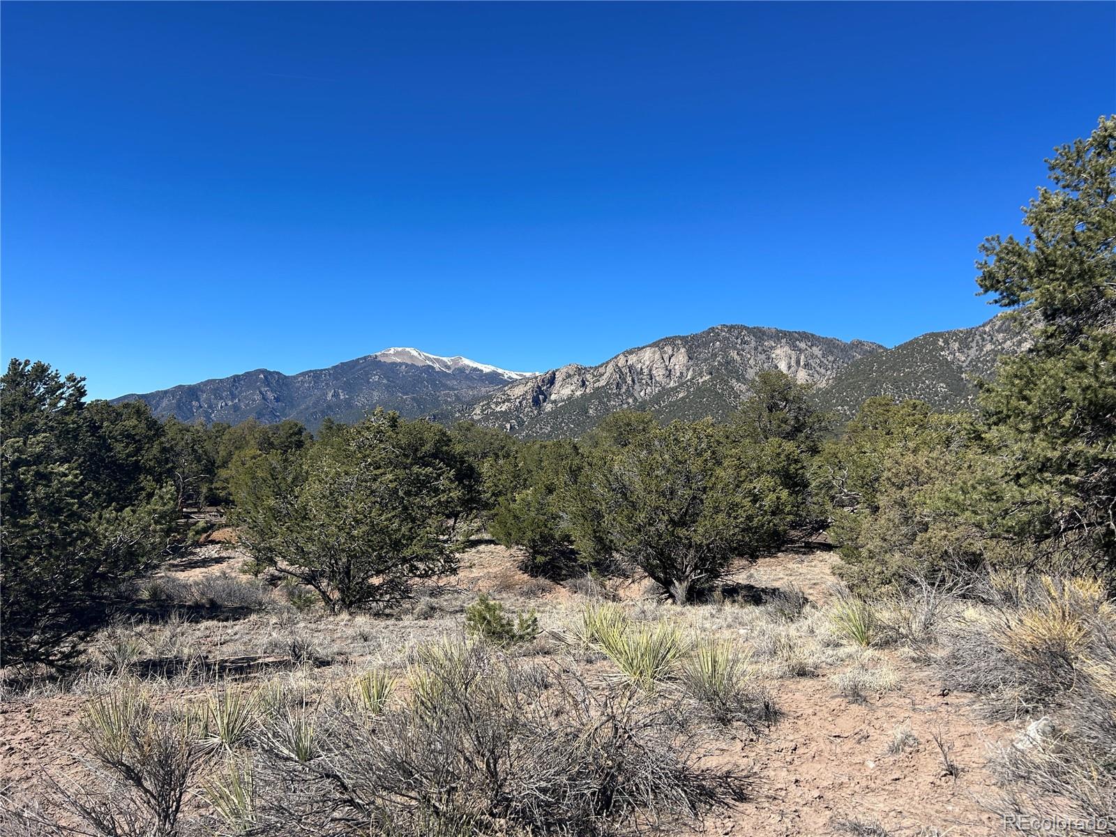626 Panorama Way Crestone, CO 81131 - Photo 1 of 12 a view of a dry yard with mountains in the background