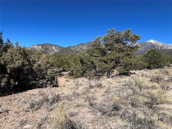 a view of a snow covered with snow in the background