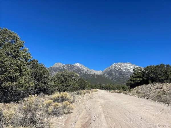 a view of a road with a snow in the background
