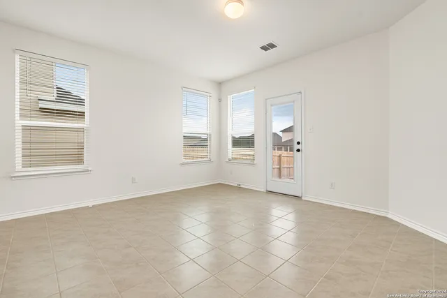 an empty room with windows and closet