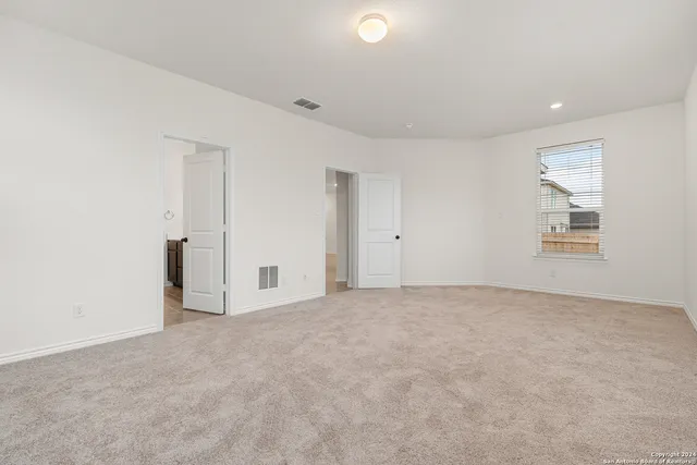 an empty room with windows and closet