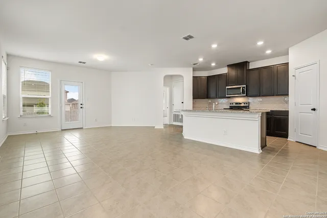 a kitchen with stainless steel appliances a refrigerator sink and microwave
