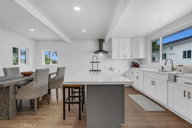 a kitchen with stainless steel appliances granite countertop white cabinets and a sink