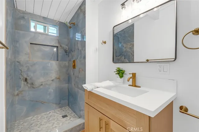 an empty room with wooden floor and white walls