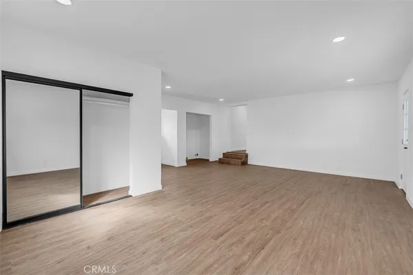 an empty room with window and cabinet