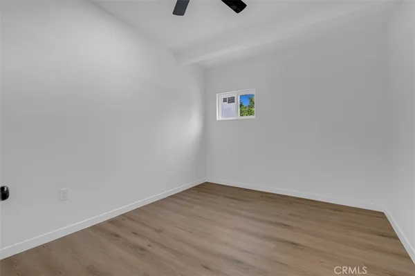 a view of a kitchen with wooden floor and a kitchen