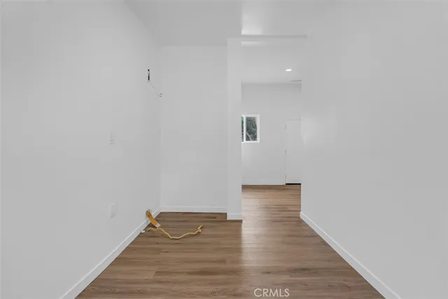 a large white kitchen with stainless steel appliances granite countertop lots of counter space and a sink