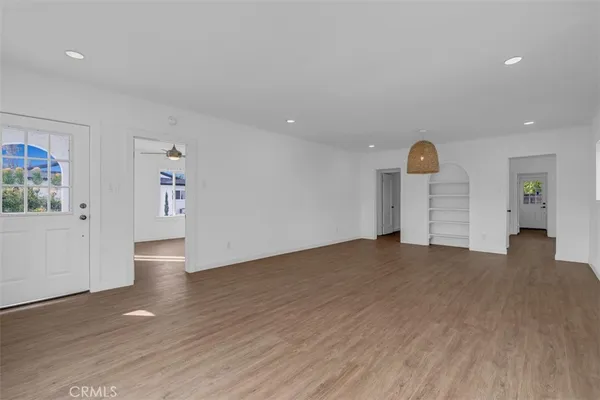 a view of a room with wooden floor and windows