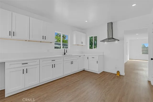 a view of empty room with wooden floor and fireplace