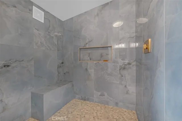 a view of a hallway with wooden floor and a potted plant