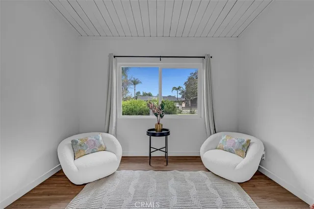 a kitchen with granite countertop a table chairs a sink dishwasher stove and cabinets with wooden floor