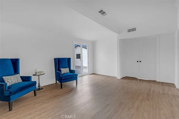 a room with a walk in closet and wooden floor