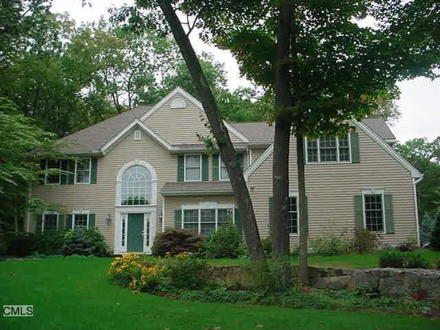 7 Clapboard Ridge Newtown, CT 06482 - Photo 1 of 1 a front view of a house with a yard and trees