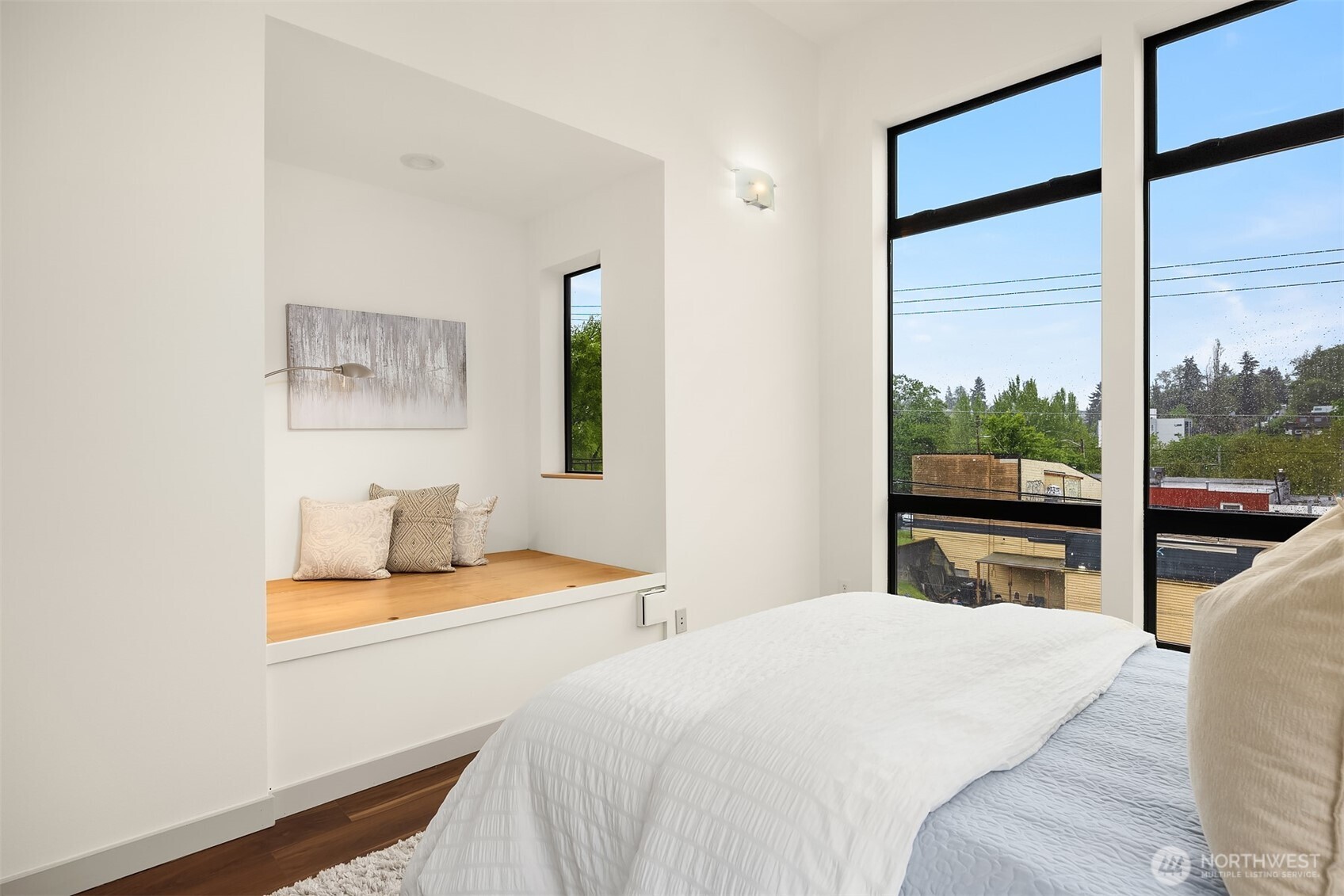 3818 South Hudson Street, Unit A Seattle, WA 98118 - Photo 15 of 31 a bedroom with a bed and wooden floor