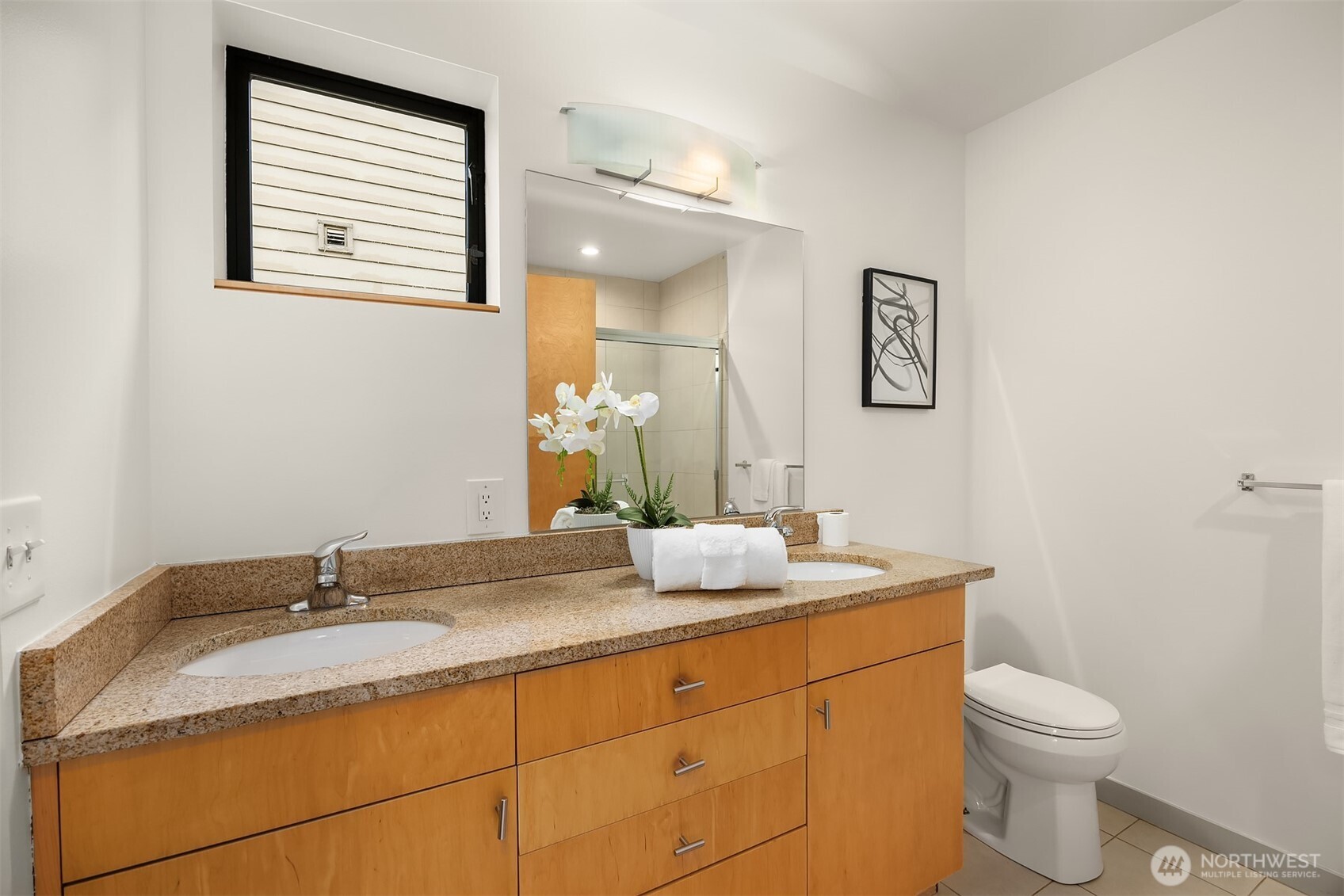 3818 South Hudson Street, Unit A Seattle, WA 98118 - Photo 16 of 31 a bathroom with a granite countertop sink toilet and mirror