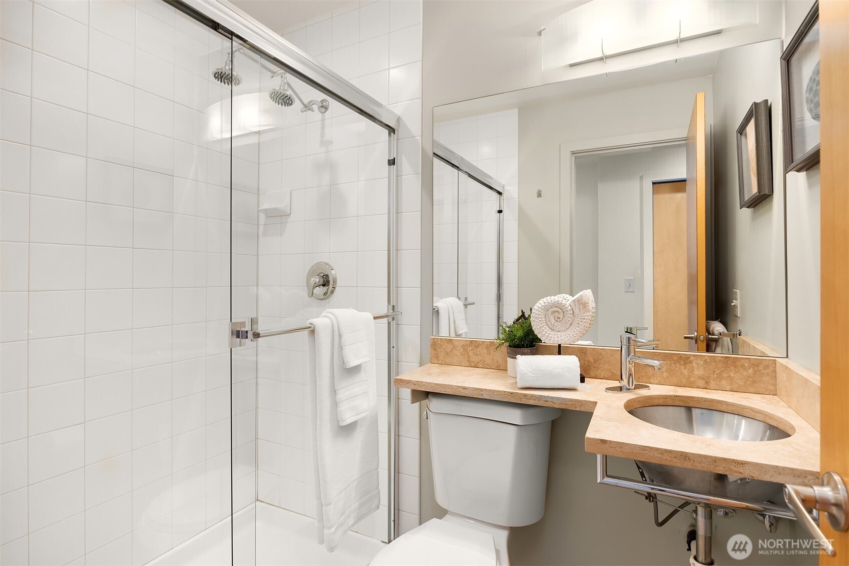 3818 South Hudson Street, Unit A Seattle, WA 98118 - Photo 22 of 31 a bathroom with a double vanity sink a mirror and a shower