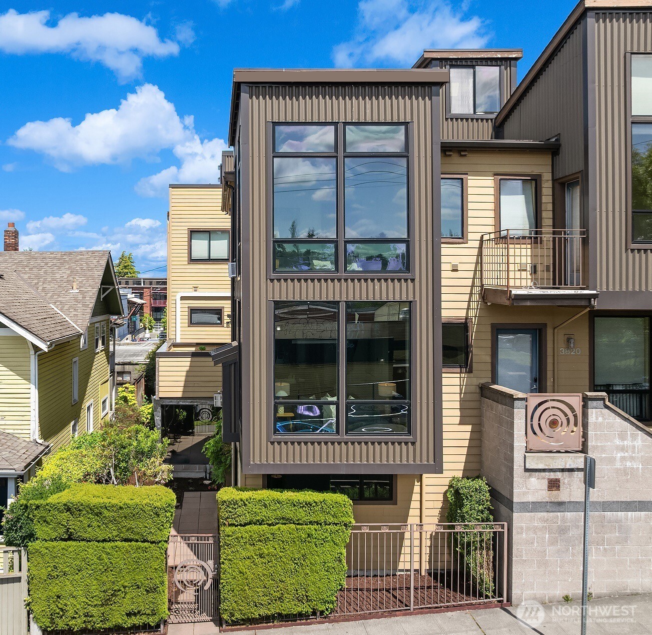 3818 South Hudson Street, Unit A Seattle, WA 98118 - Photo 4 of 31 a view of a brick house with large windows and a outdoor view
