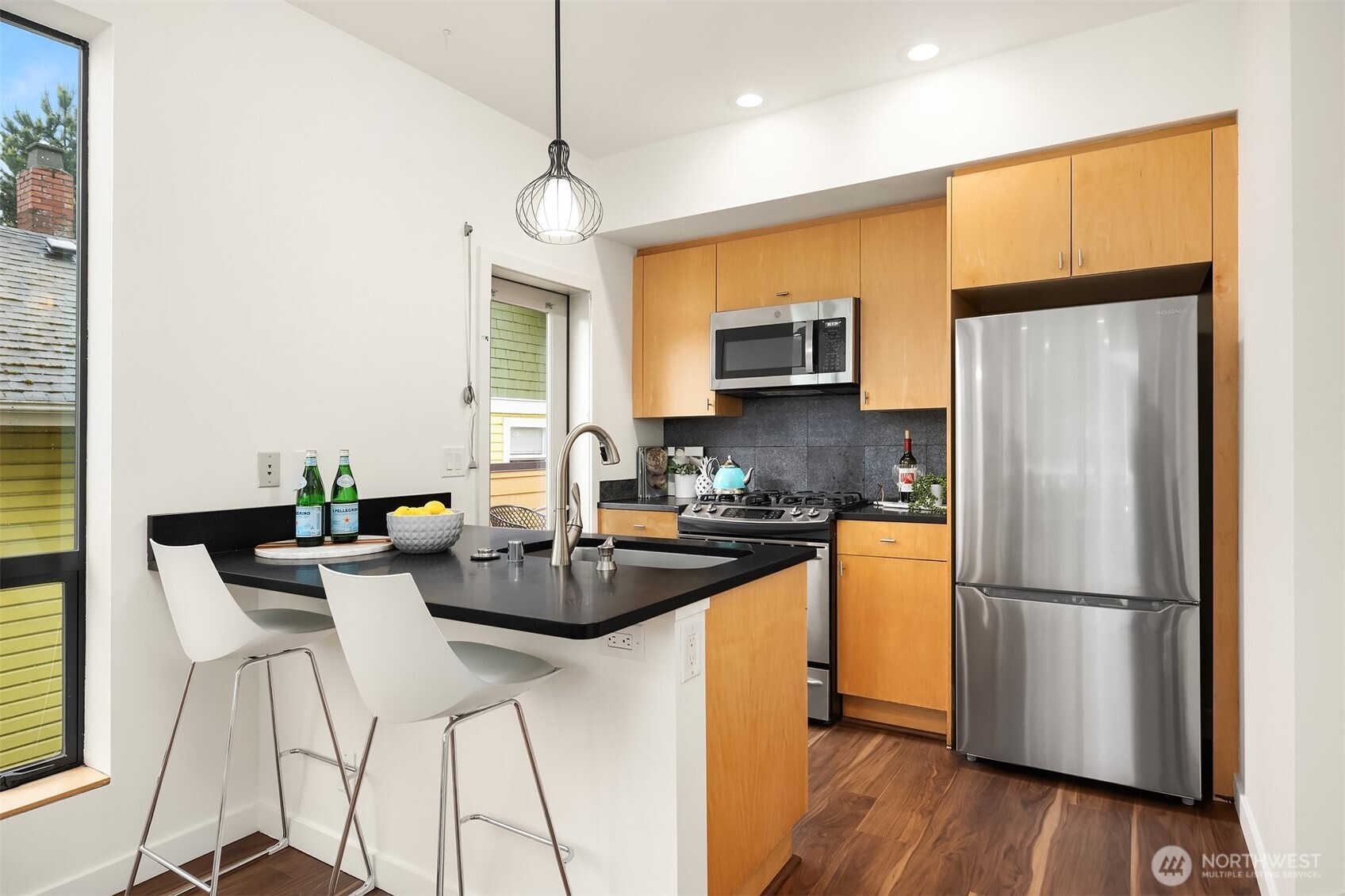 3818 South Hudson Street, Unit A Seattle, WA 98118 - Photo 9 of 31 a kitchen with kitchen island a counter top space appliances and cabinets