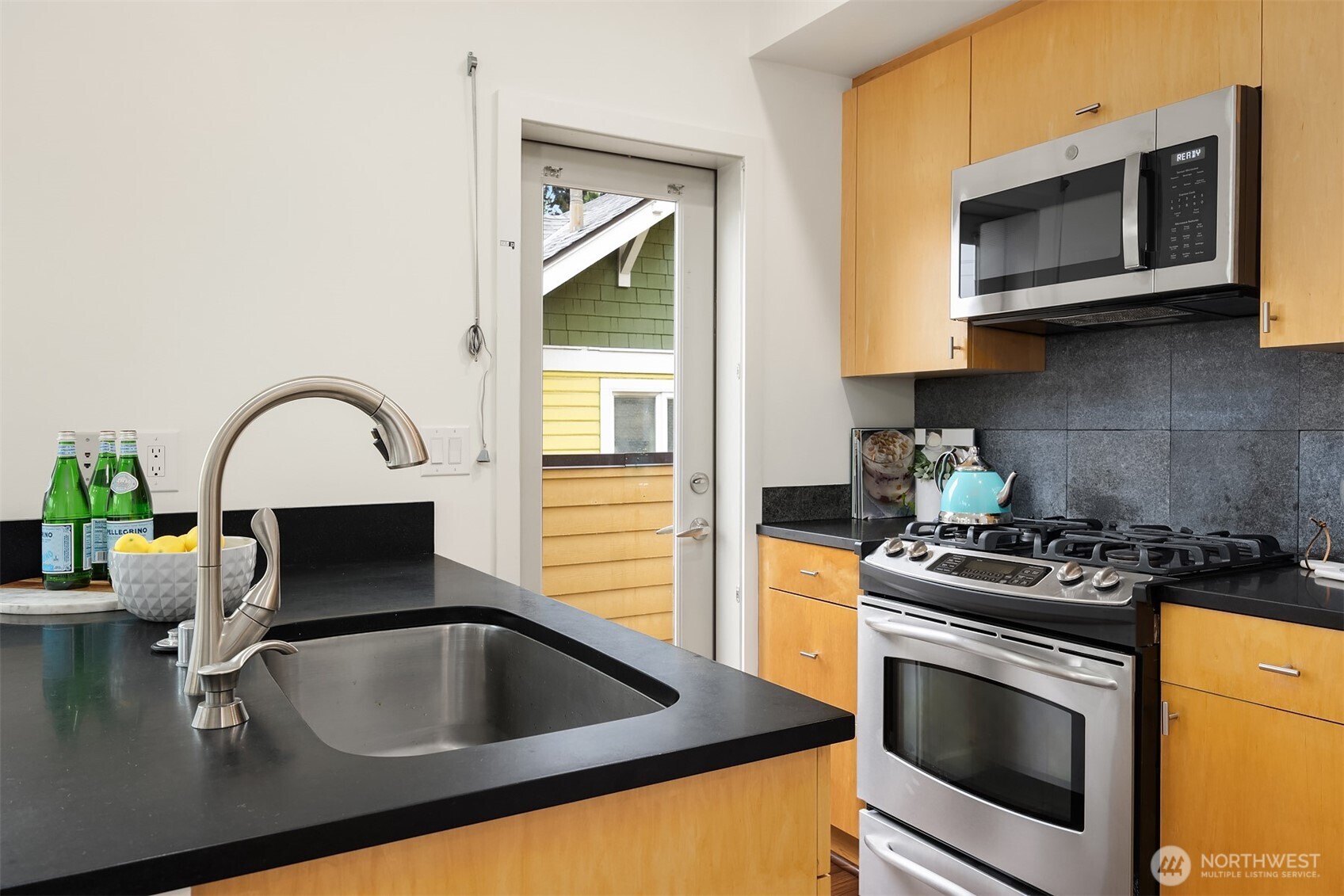3818 South Hudson Street, Unit A Seattle, WA 98118 - Photo 10 of 31 a kitchen with a sink and a stove top oven