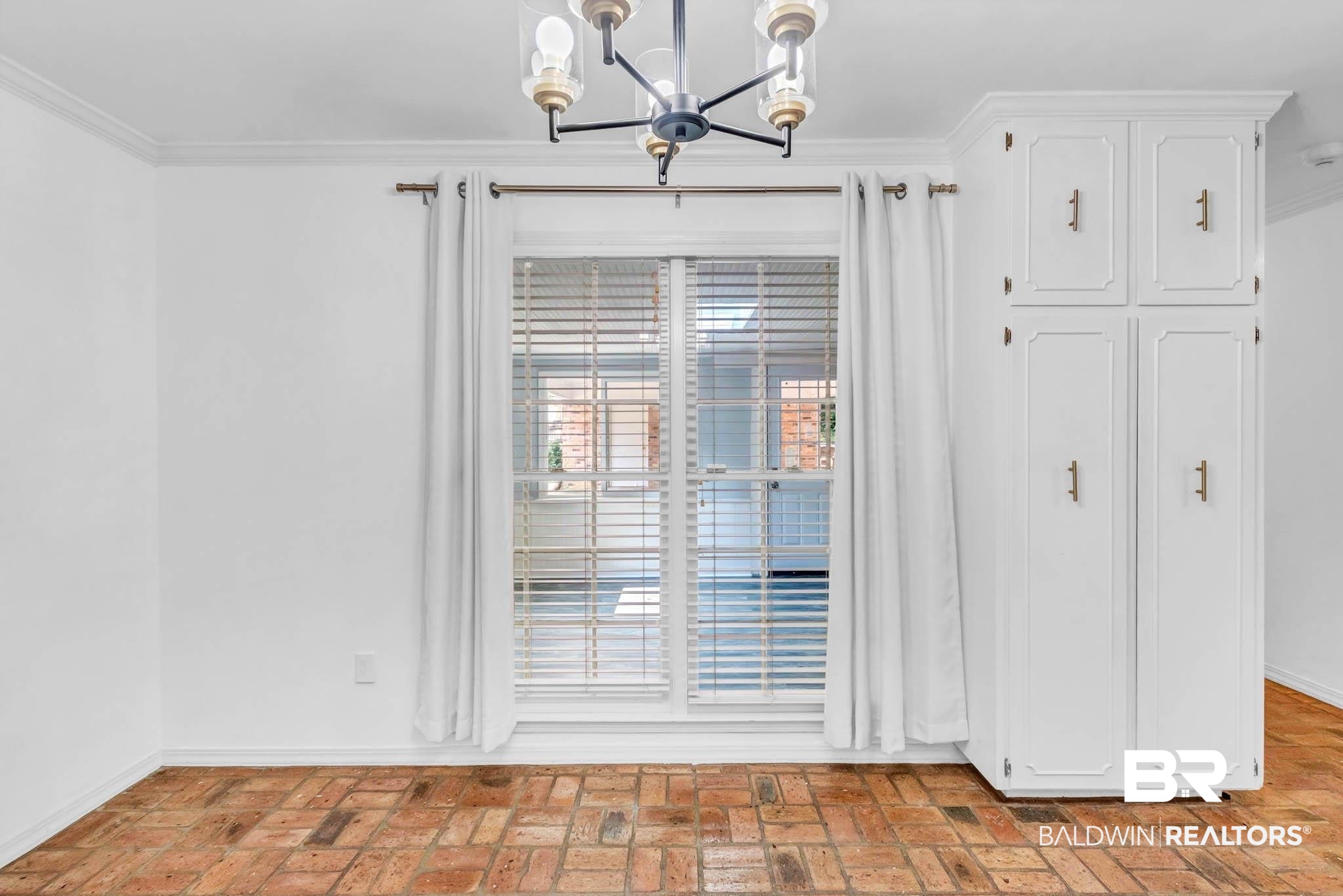 309 West Brandy Run Road Mobile, AL 36608 - Photo 27 of 100 Unfurnished dining area featuring ornamental molding, a chandelier, and brick floors