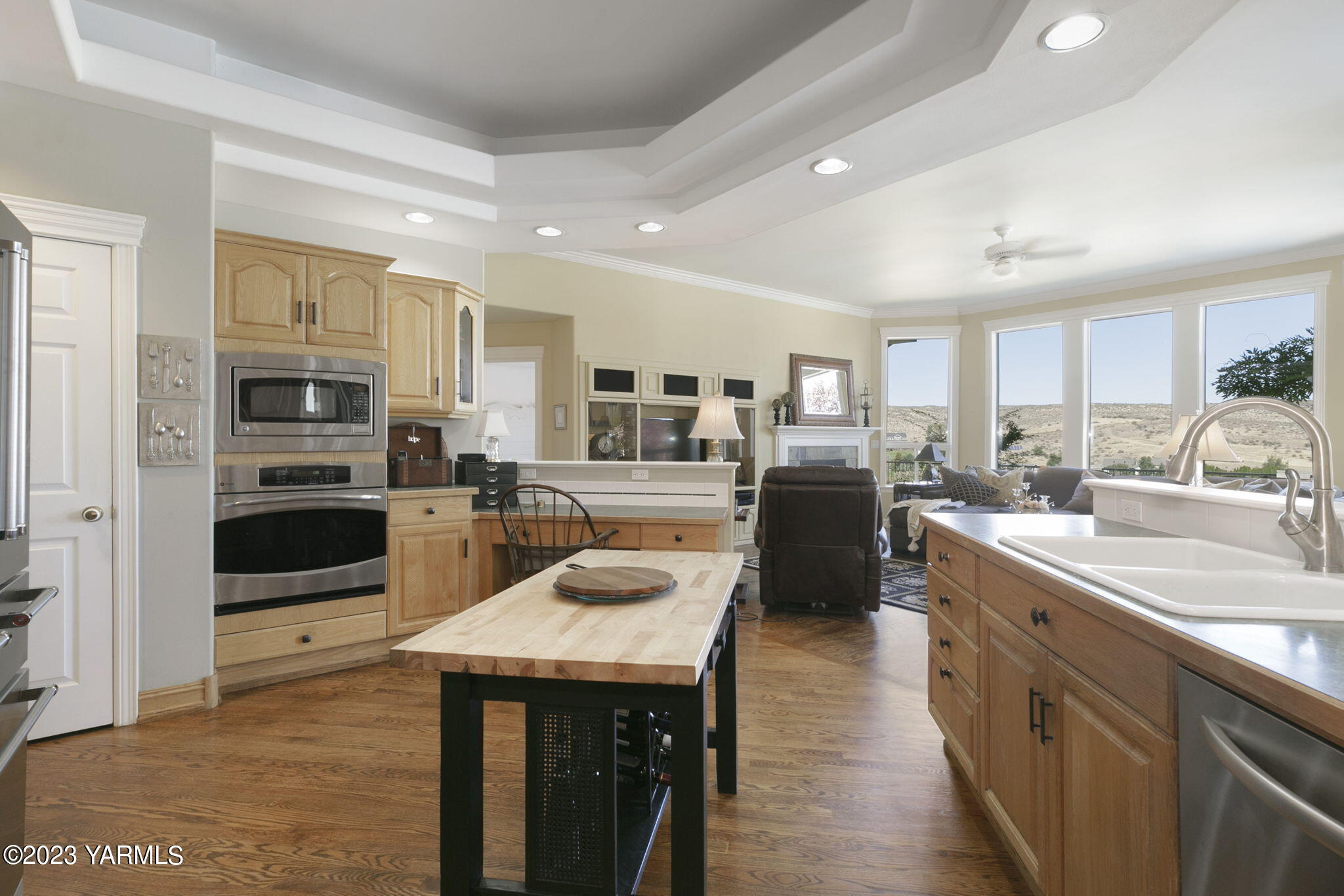 11521 Marble Extension Yakima, WA 98908 - Photo 11 of 40 a kitchen with stainless steel appliances granite countertop a refrigerator a stove top oven a sink dishwasher and white cabinets with wooden floor