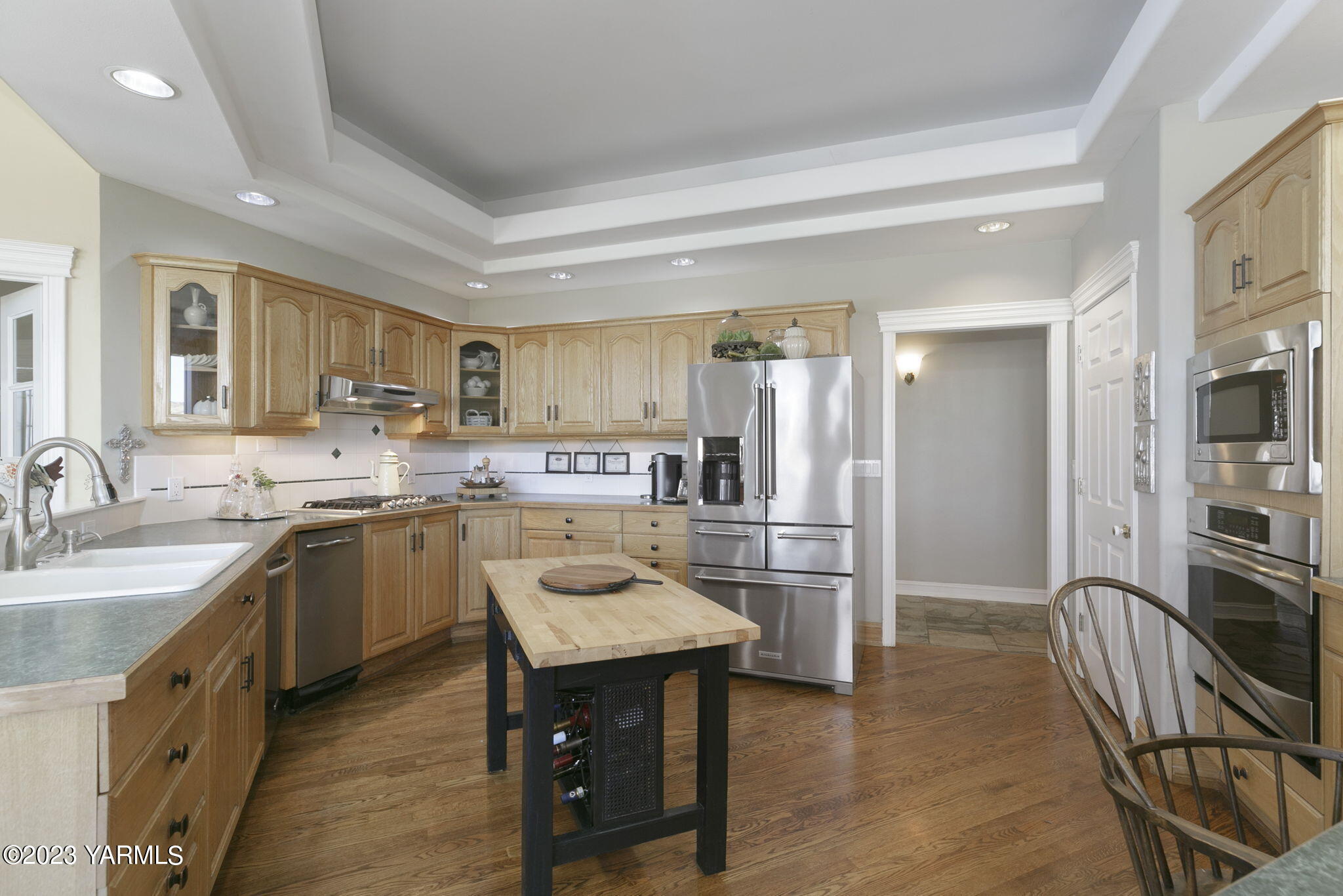 11521 Marble Extension Yakima, WA 98908 - Photo 12 of 40 a kitchen with refrigerator cabinets dining table and chairs