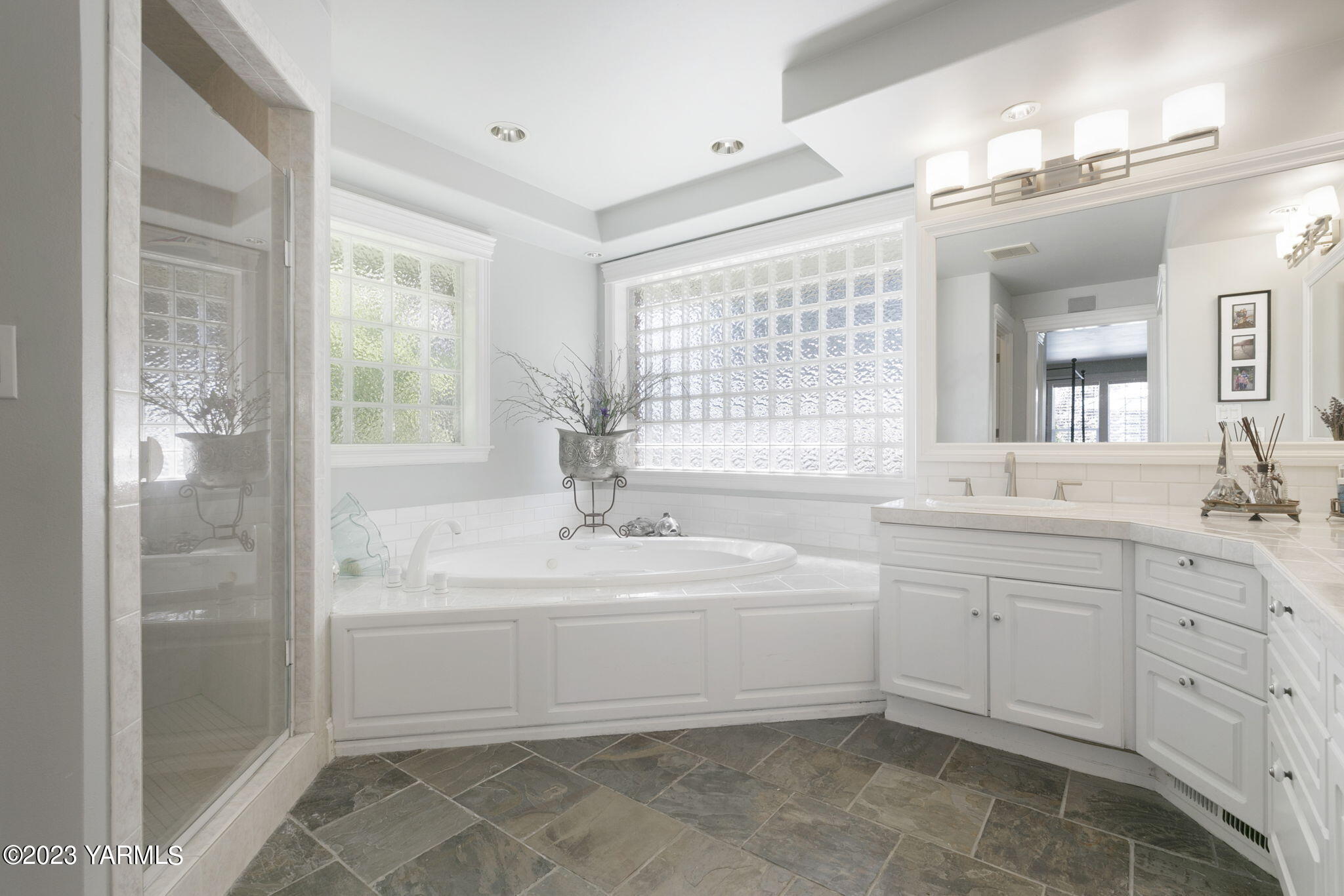 11521 Marble Extension Yakima, WA 98908 - Photo 17 of 40 a spacious bathroom with a double vanity sink a mirror and a bathtub