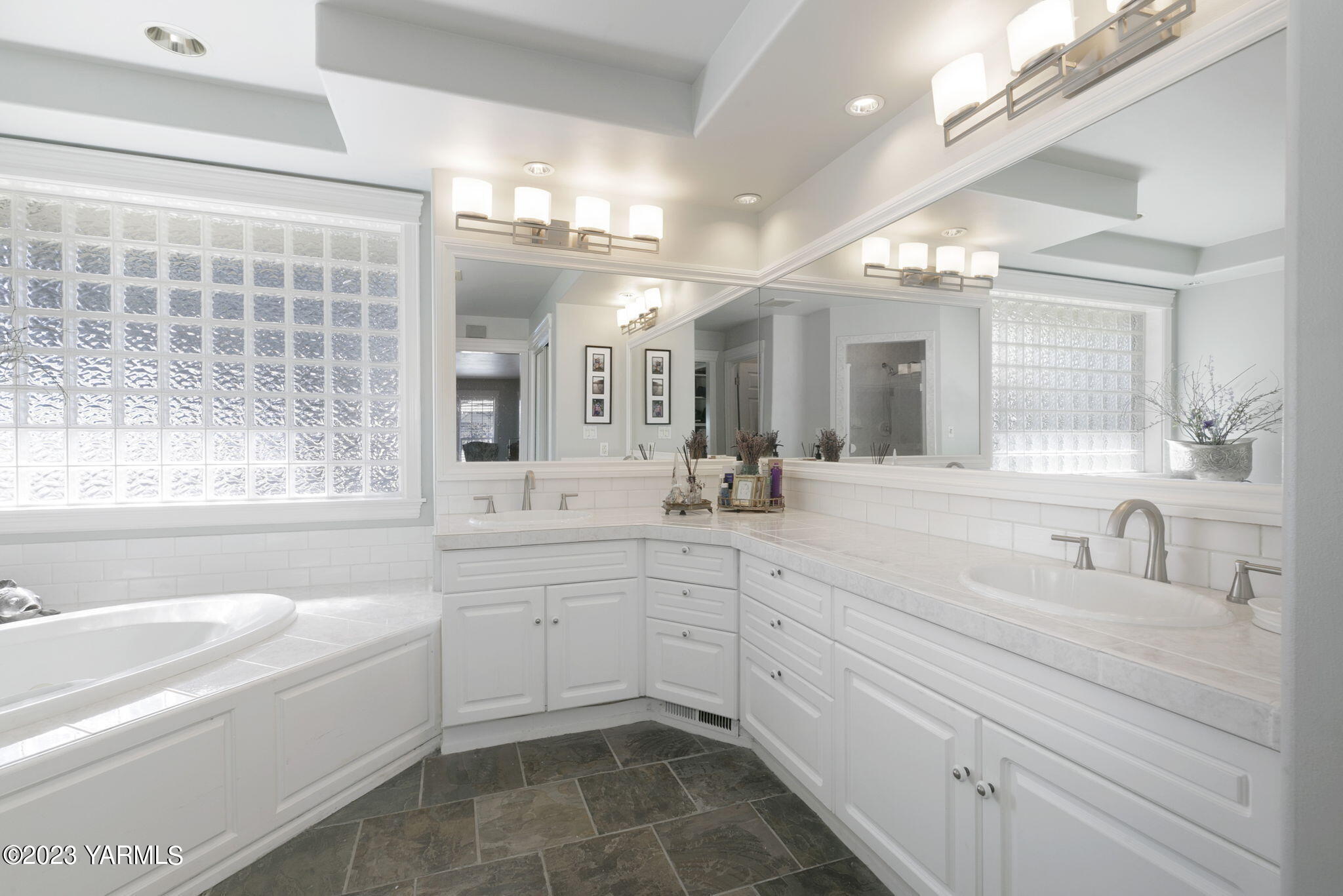 11521 Marble Extension Yakima, WA 98908 - Photo 18 of 40 a bathroom with a sink a large mirror and a bathtub with shower