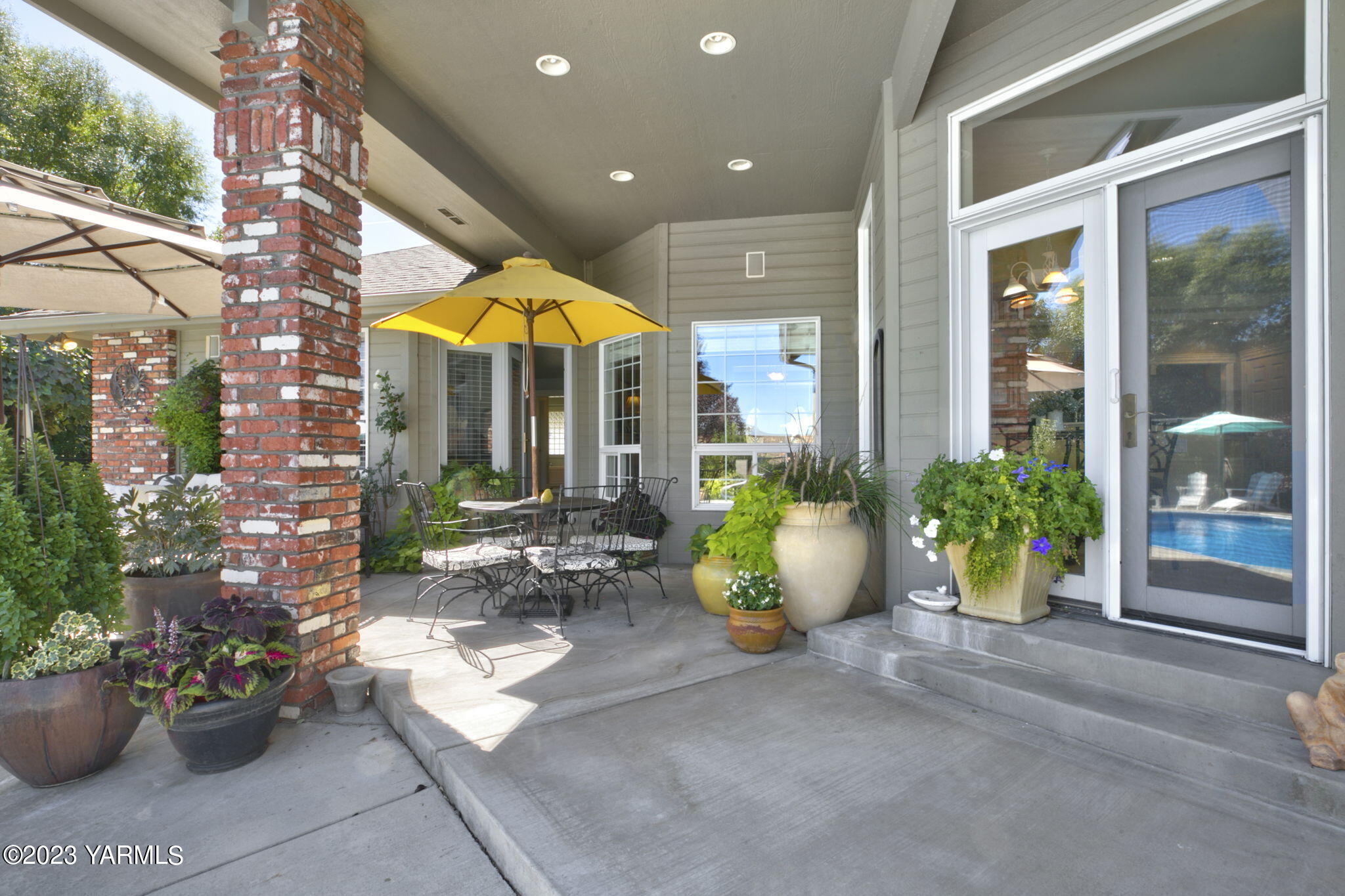 11521 Marble Extension Yakima, WA 98908 - Photo 25 of 40 a view of a patio with dining table and chairs and potted plants