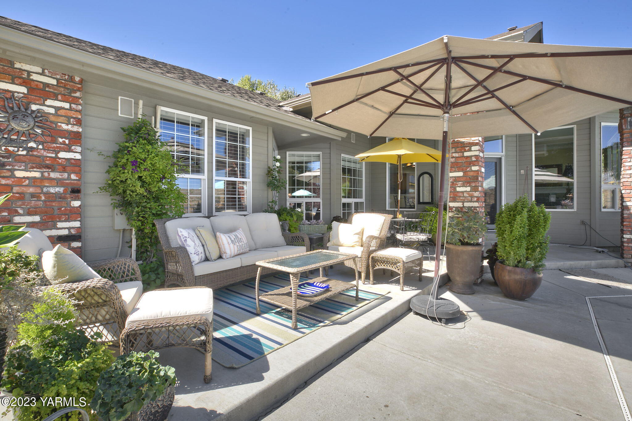 11521 Marble Extension Yakima, WA 98908 - Photo 27 of 40 a view of a patio with couches table and chairs under an umbrella