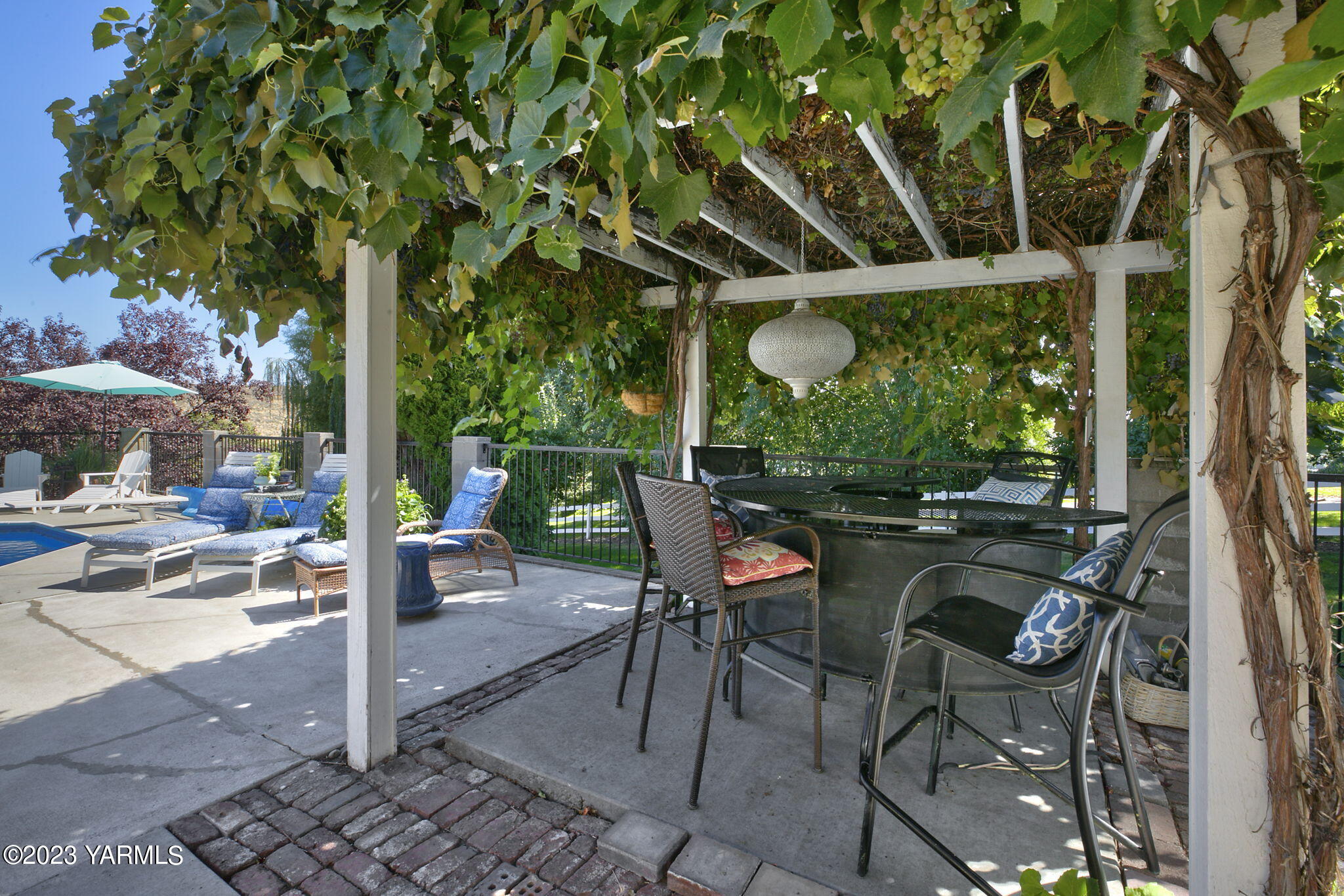 11521 Marble Extension Yakima, WA 98908 - Photo 30 of 40 a view of a patio with table and chairs potted plants and large tree