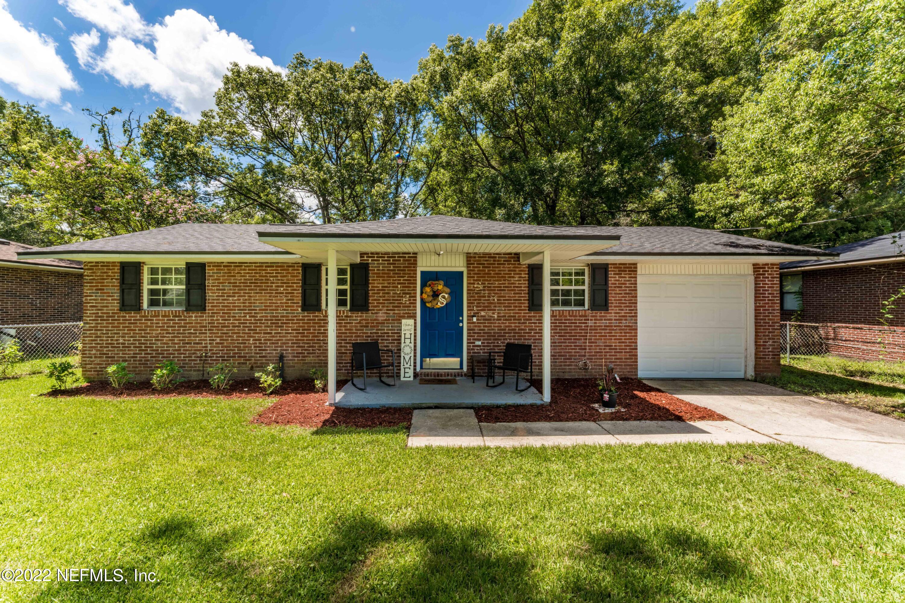 648 West Oliver Street Baldwin, FL 32234 - Photo 1 of 30 a view of a house with backyard and sitting area