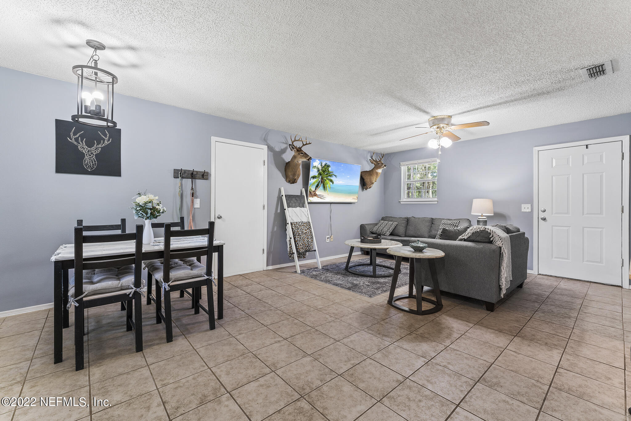 648 West Oliver Street Baldwin, FL 32234 - Photo 13 of 30 a living room with furniture and a dining table