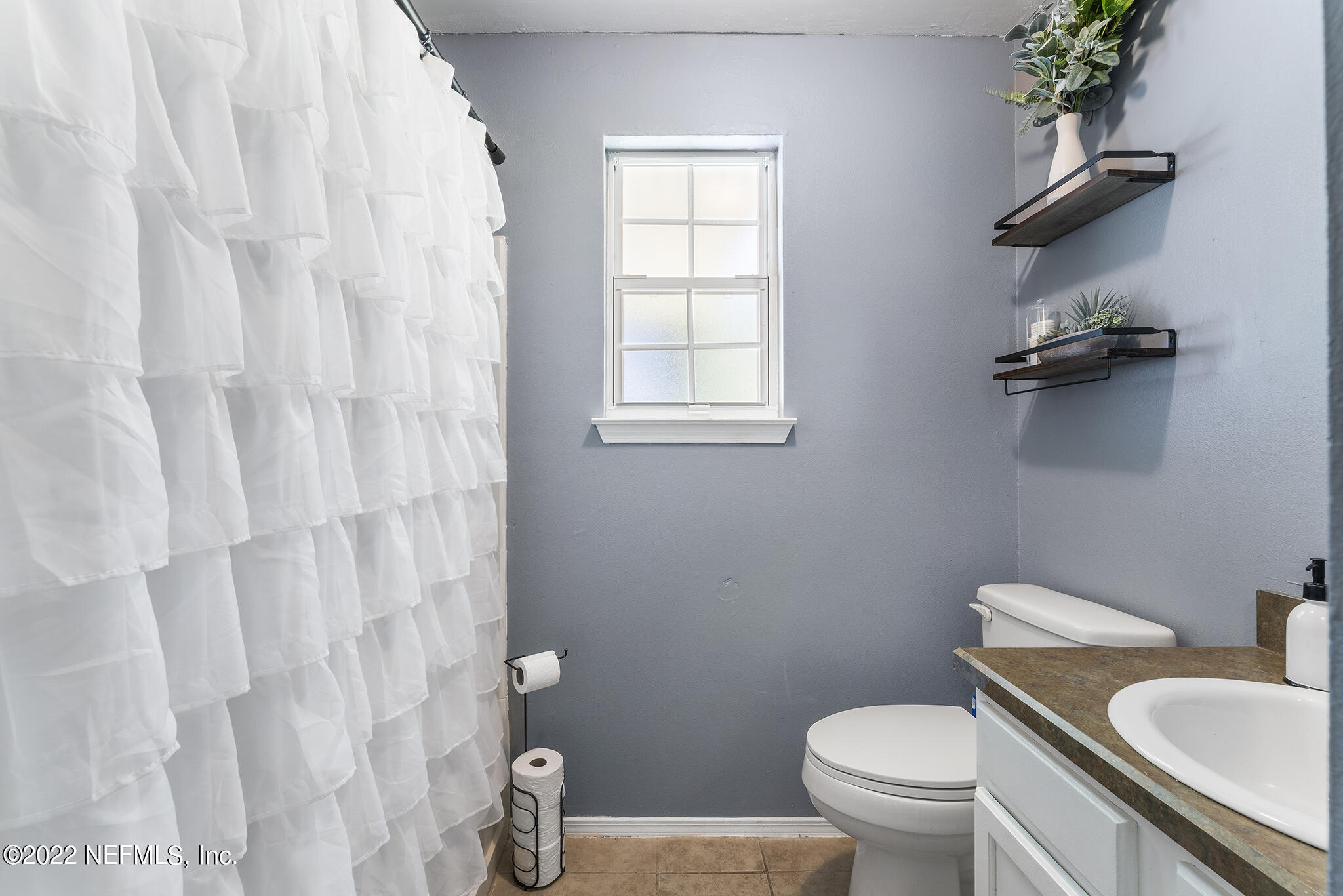 648 West Oliver Street Baldwin, FL 32234 - Photo 14 of 30 a white toilet sitting next to a bathroom sink