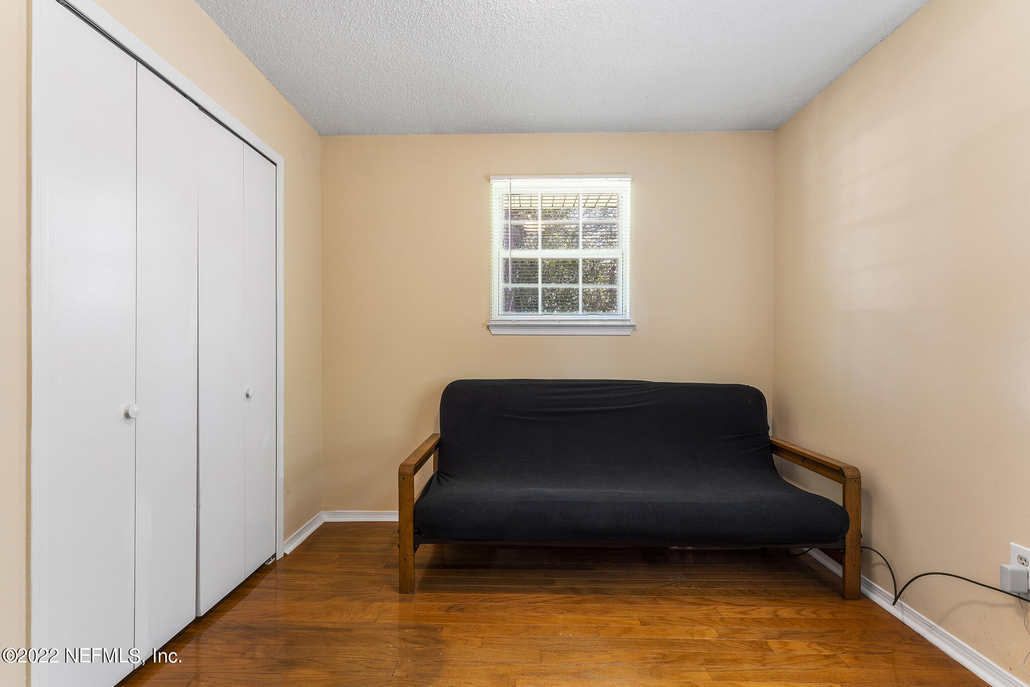 648 West Oliver Street Baldwin, FL 32234 - Photo 17 of 30 a room with a chair and wooden floor