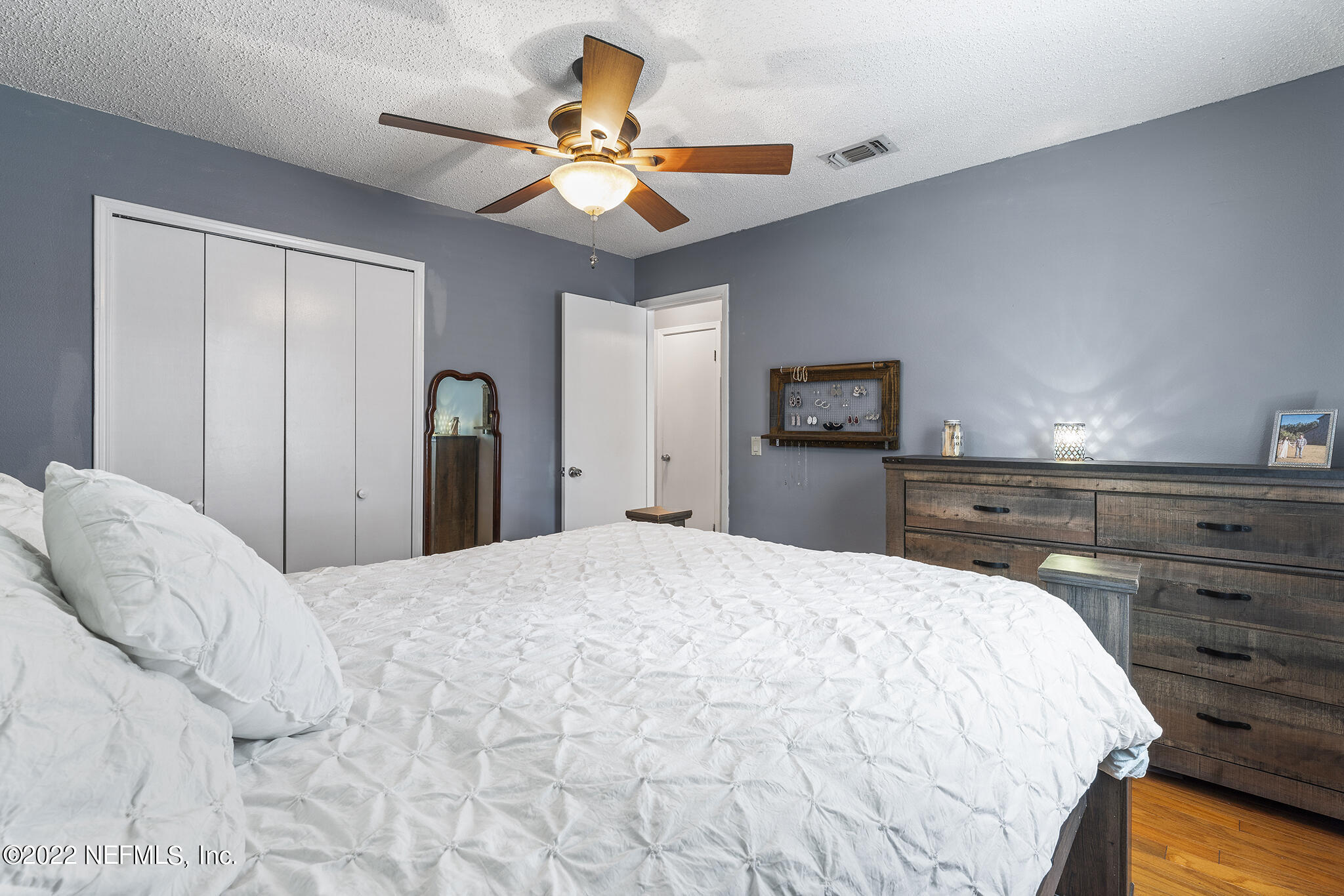 648 West Oliver Street Baldwin, FL 32234 - Photo 20 of 30 a bedroom with a bed and a chandelier