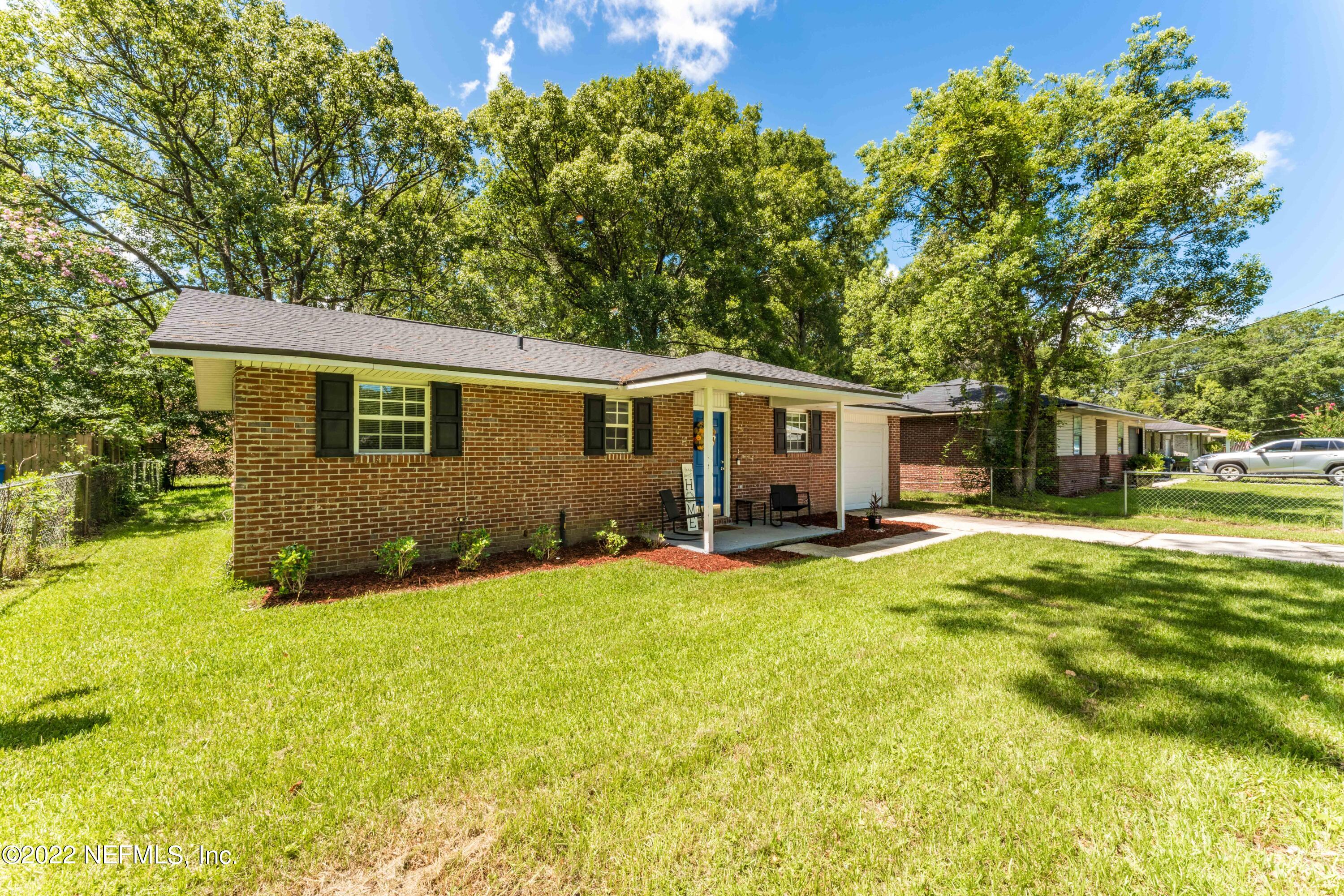 648 West Oliver Street Baldwin, FL 32234 - Photo 25 of 30 a view of a house with a yard and a tree