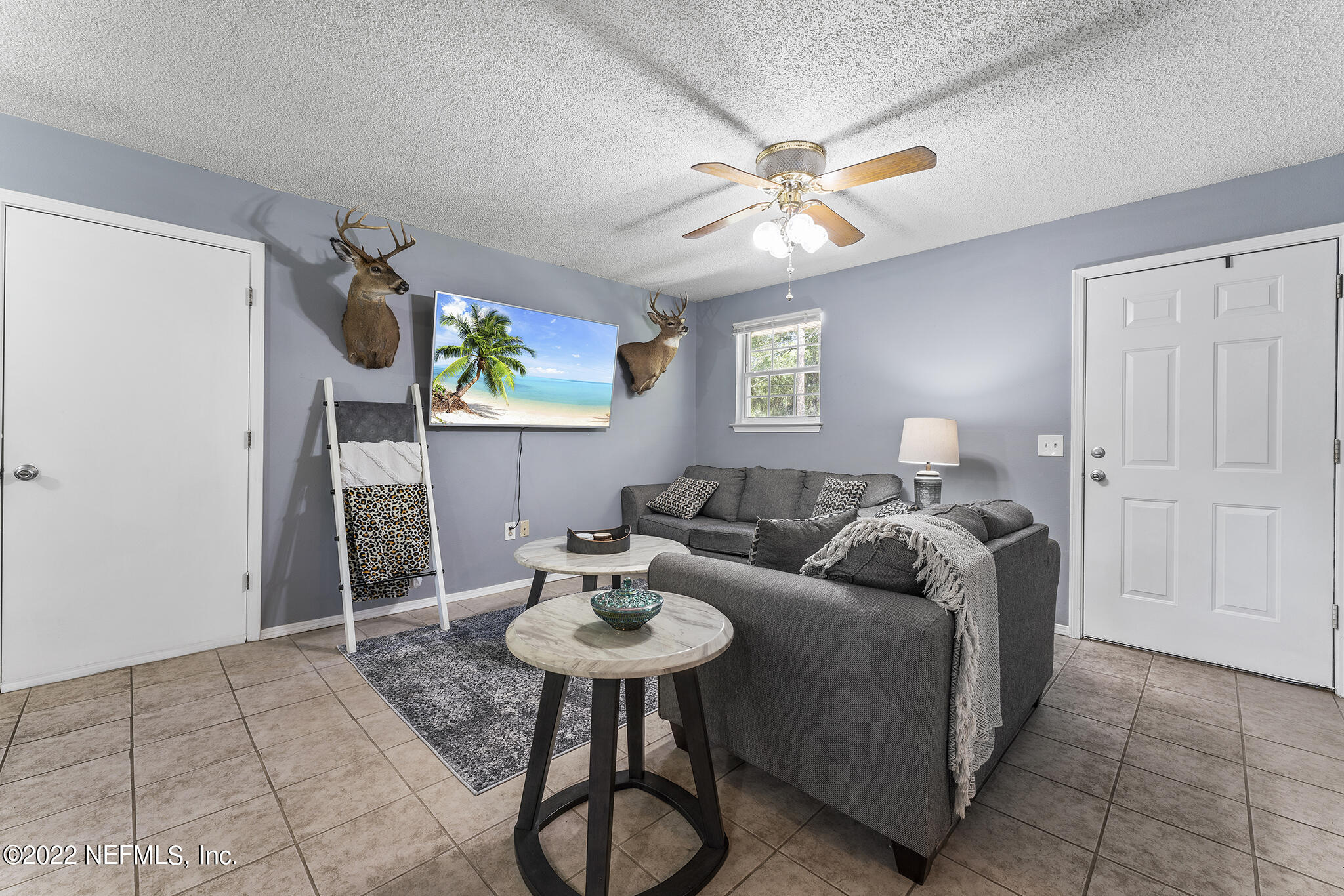 648 West Oliver Street Baldwin, FL 32234 - Photo 5 of 30 a living room with furniture a chandelier a sink and a window