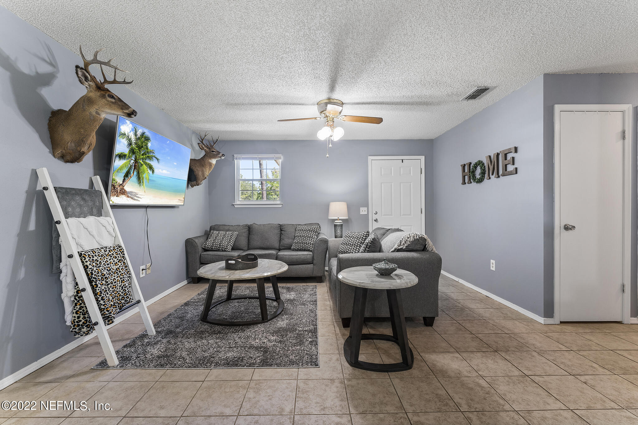648 West Oliver Street Baldwin, FL 32234 - Photo 6 of 30 a living room with furniture a chandelier and a rug