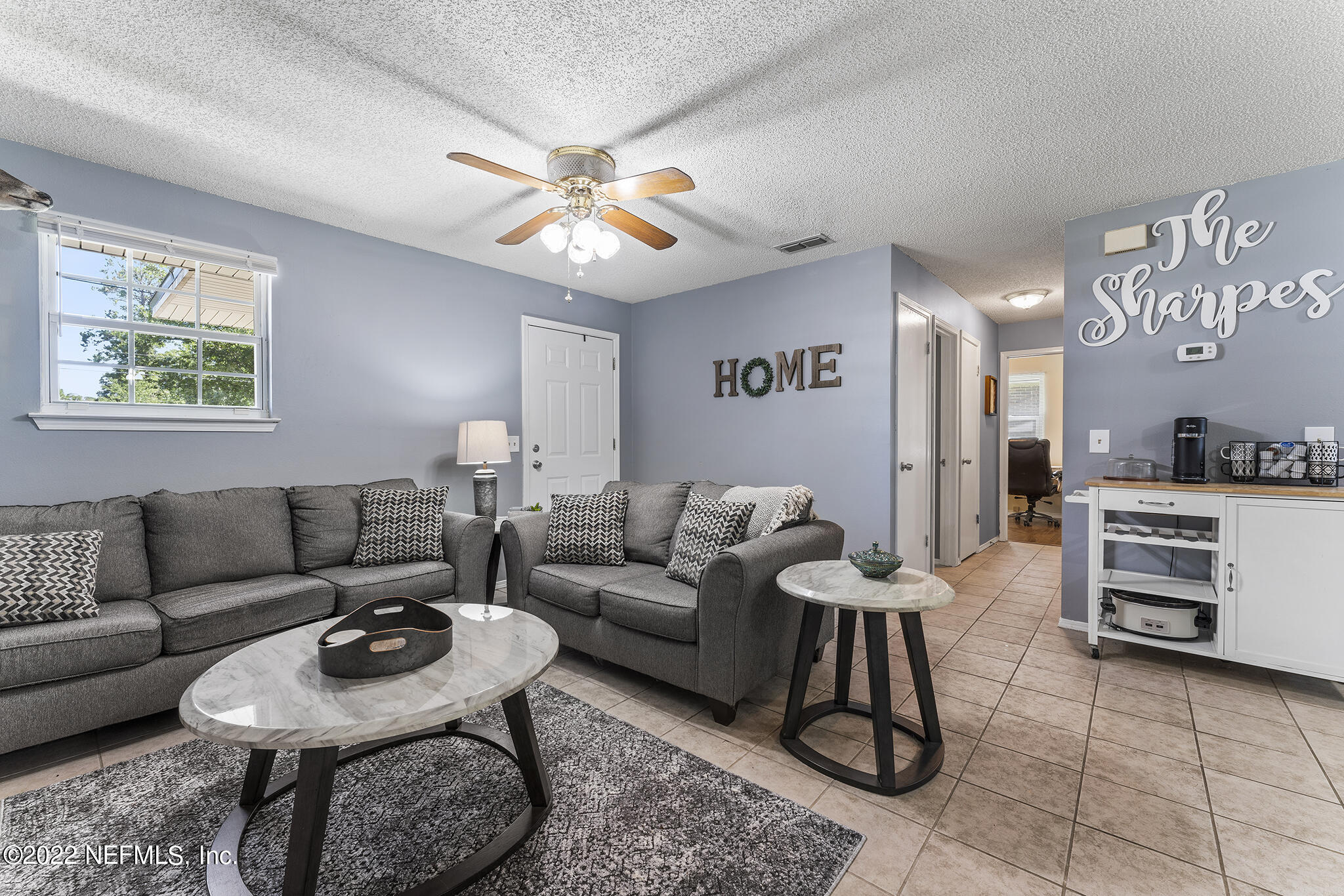 648 West Oliver Street Baldwin, FL 32234 - Photo 7 of 30 a living room with furniture a rug and kitchen view