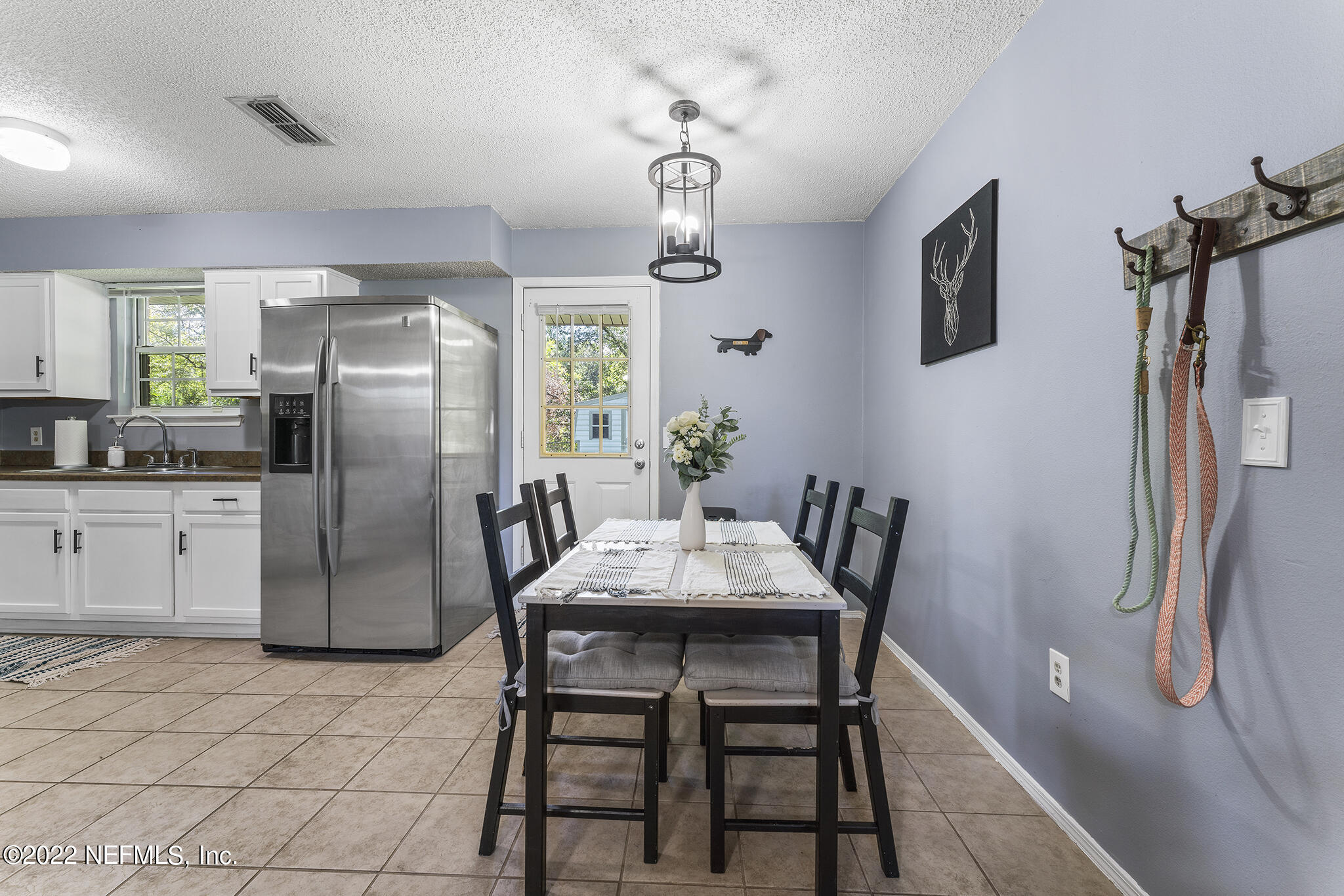 648 West Oliver Street Baldwin, FL 32234 - Photo 8 of 30 a view of a dining room with furniture window and wooden floor